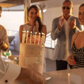 Private crewed yacht anchored in turquoise Caribbean waters during peak season